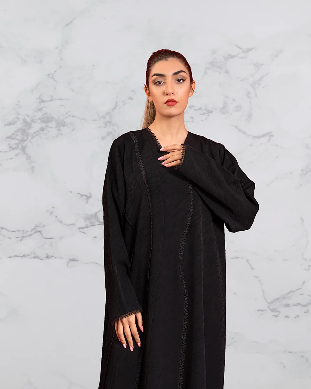 Model in a black Blue Dan abaya with lace trim